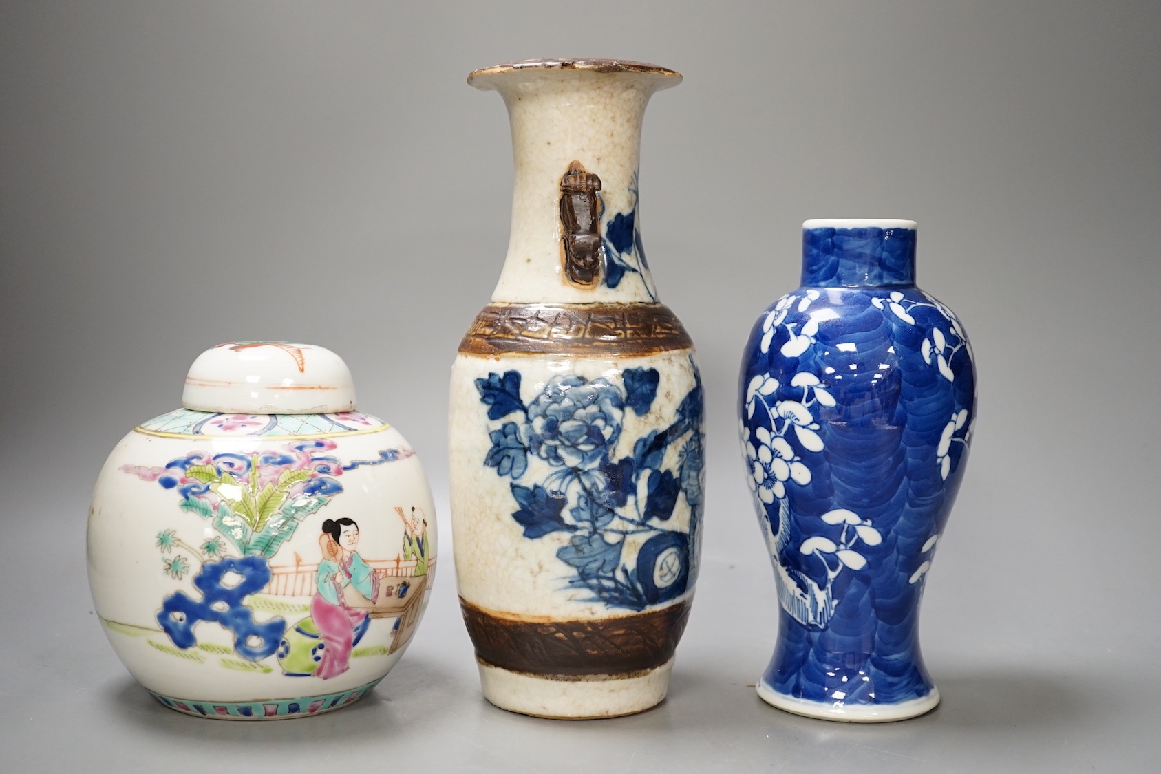 A 19th century Chinese blue and white prunus jar, a crackle glaze vase and a famille rose jar and cover